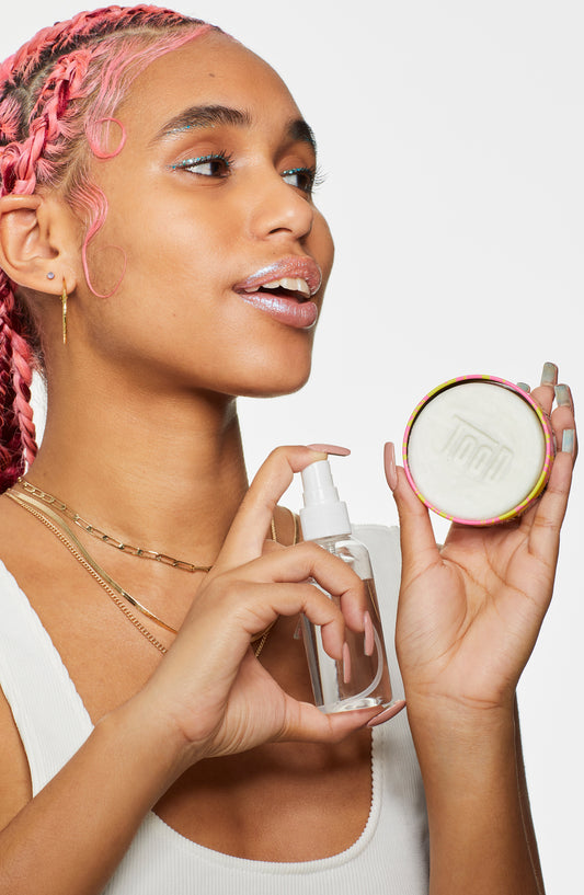 Model sprays Turn it off makeup remover to activate suds
