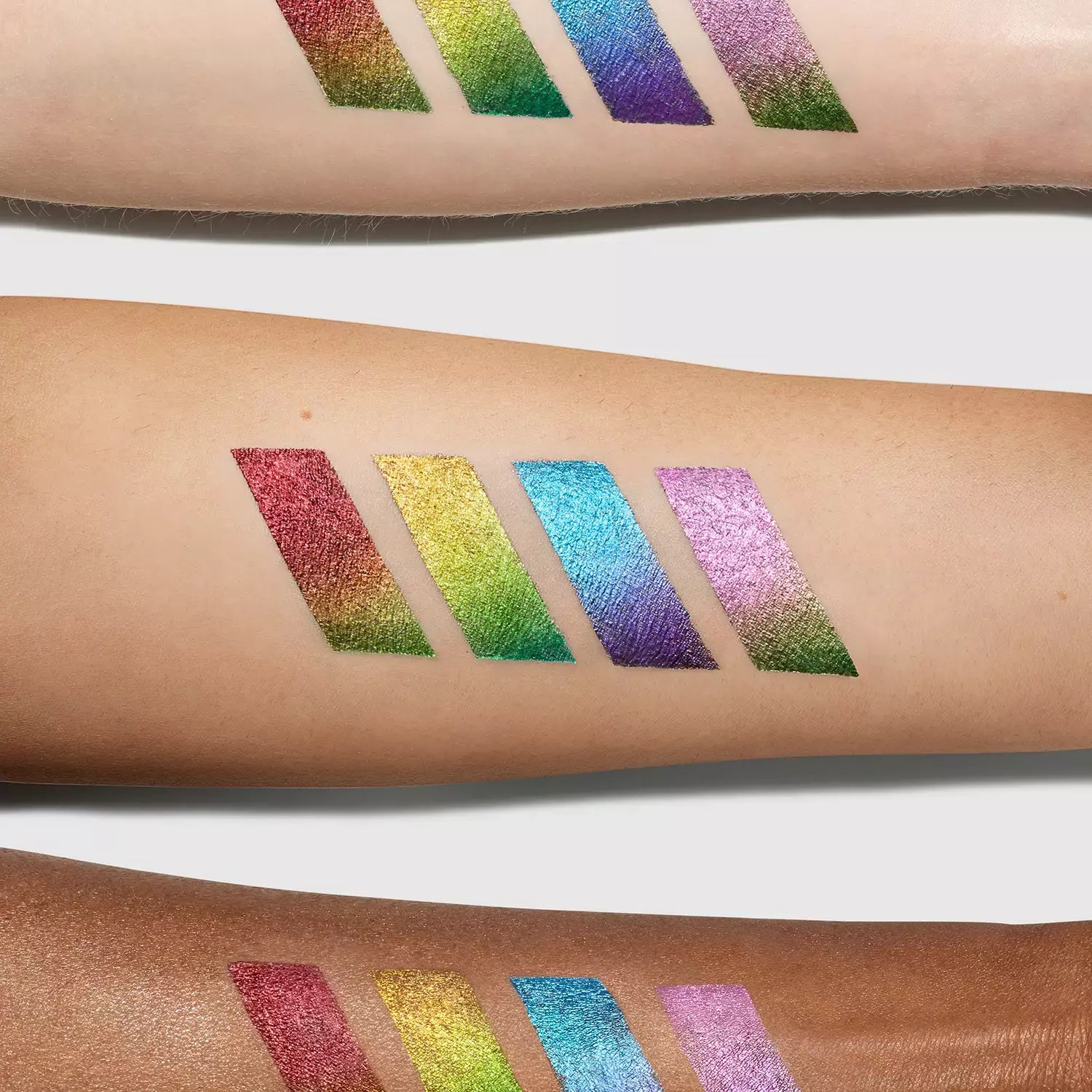 Hypnotic Color Cream multichrome eyeshadow arm swatches in four colors: Afterglow, Prism, Moondance and Cosmos.